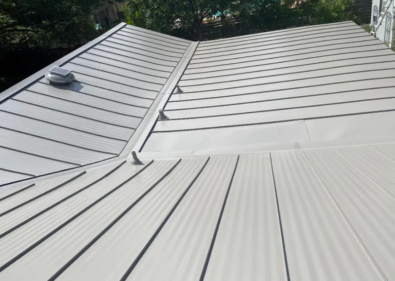 Solar attic fan installed on a metal roof for Roof Ventilation in Parole